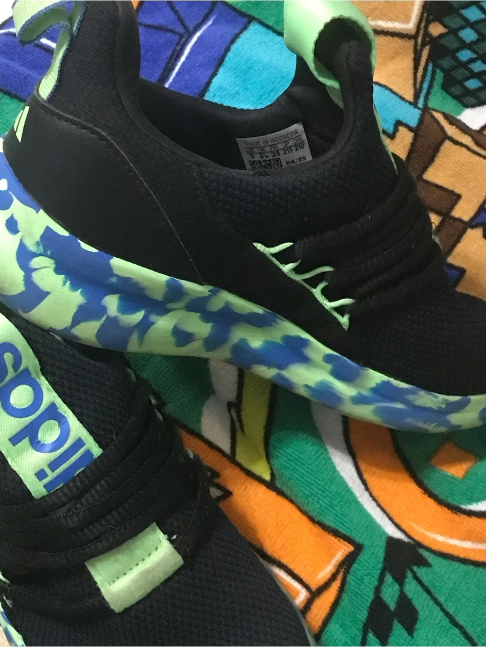 Adidas Kids Black Sneakers with Neon Green and Blue Patterned Sole